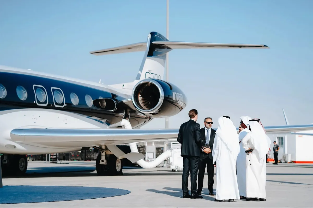 Private jet with chauffeured car waiting on the tarmac